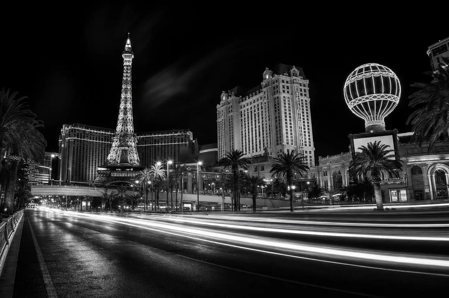 The Paris Las Vegas skyline and traffic light trails at night