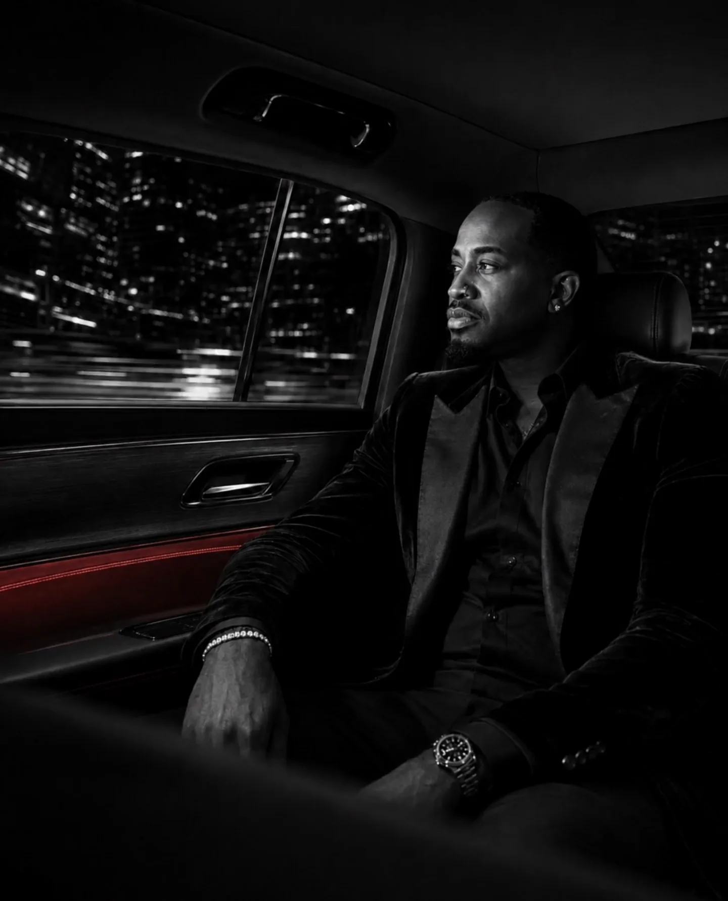 Leon, founder of Back of the Bent, seated alone in the rear of a Bentayga at night
