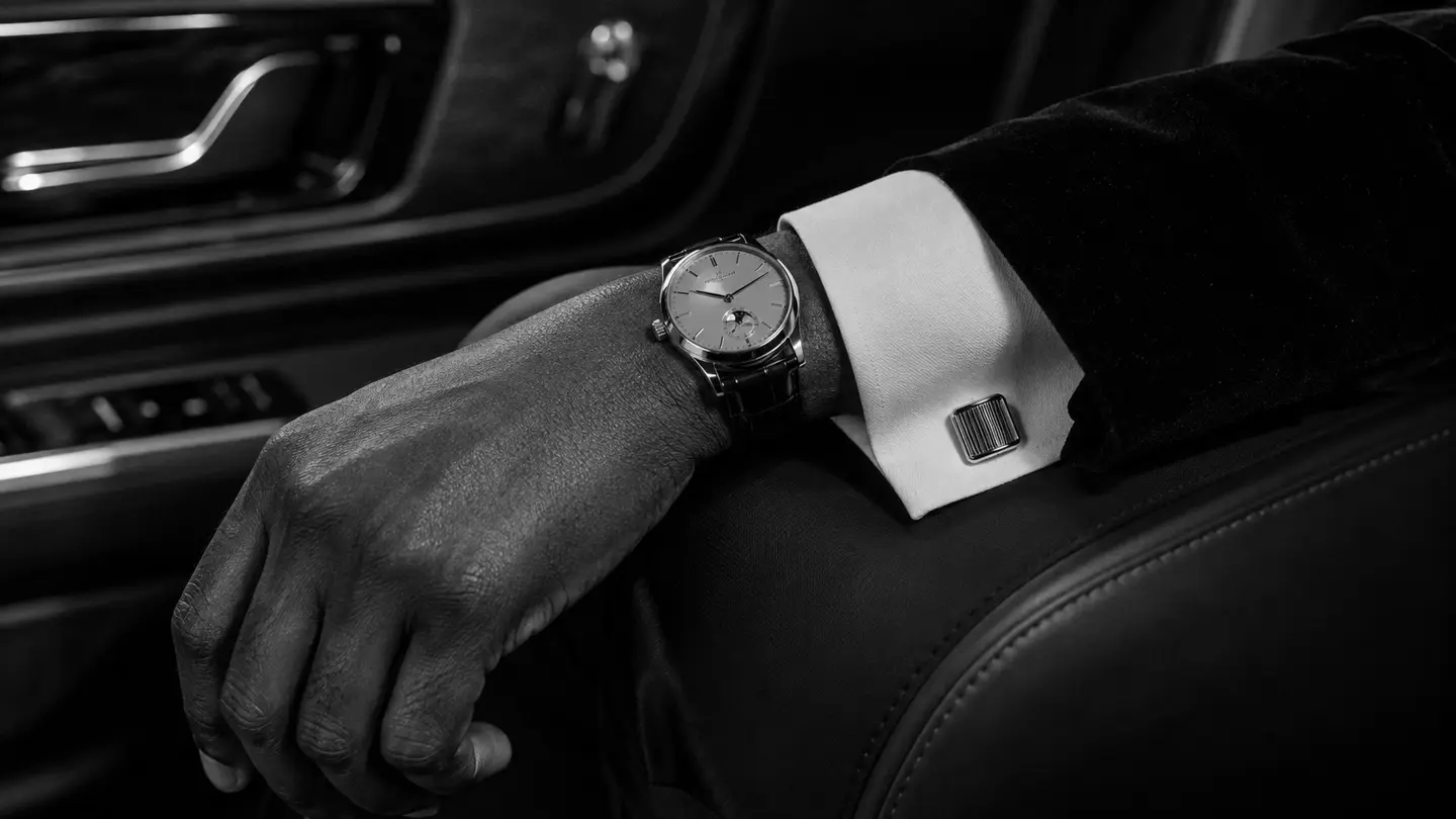 A tailored cuff, cufflink, and mechanical watch held in quiet detail